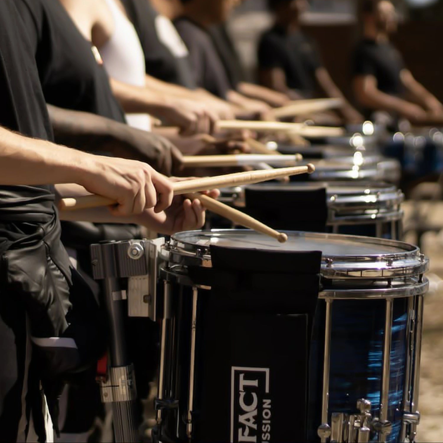 A marching snare line playing in the lot