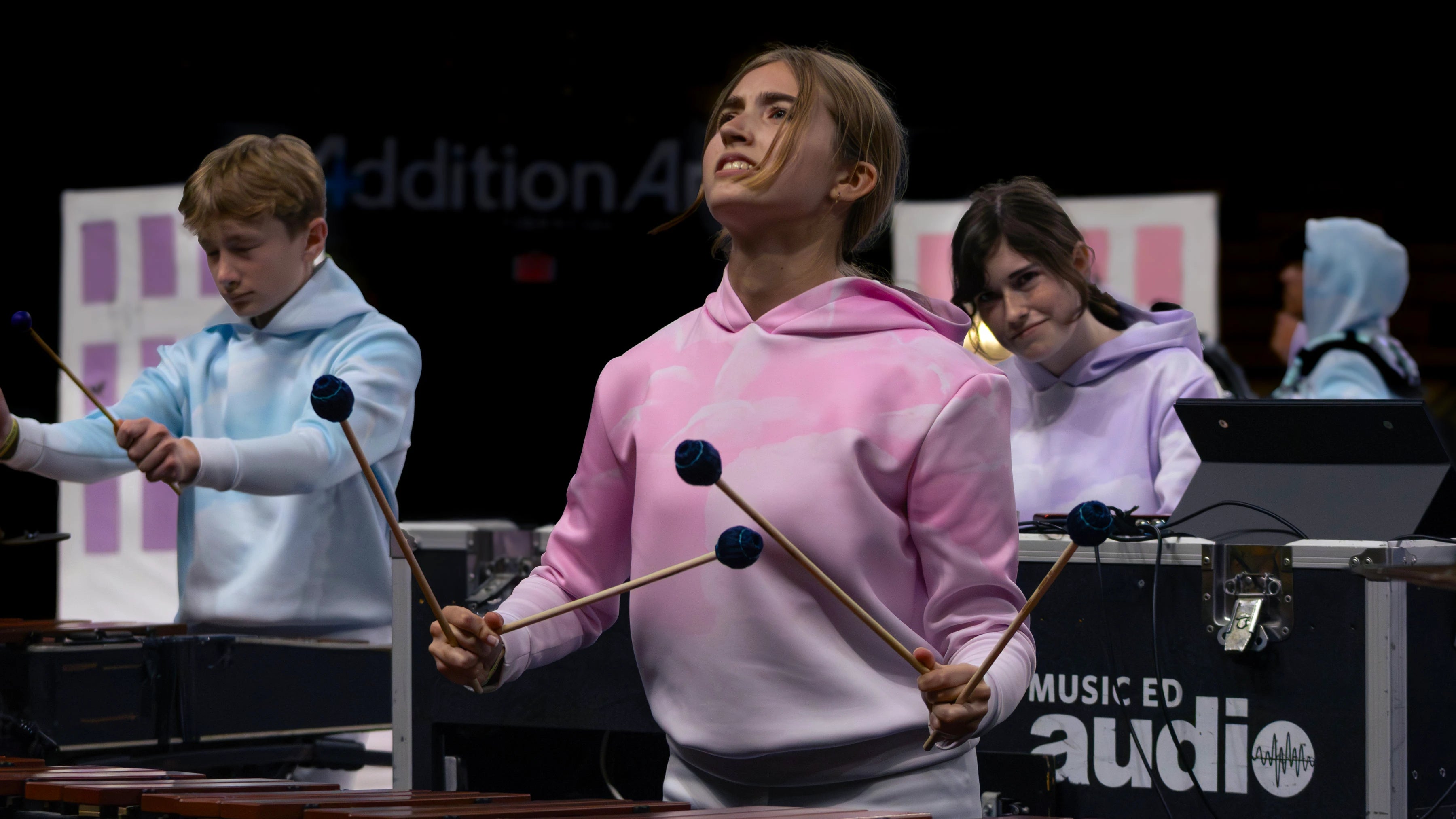 Person playing marimba on the floor in competition