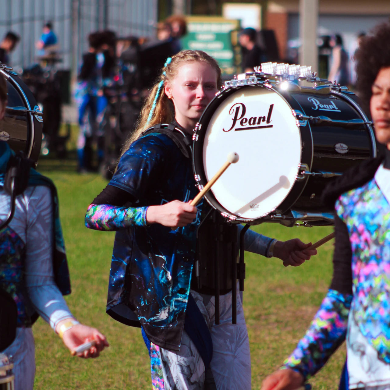 Person playing a Pearl drum with a band in the background