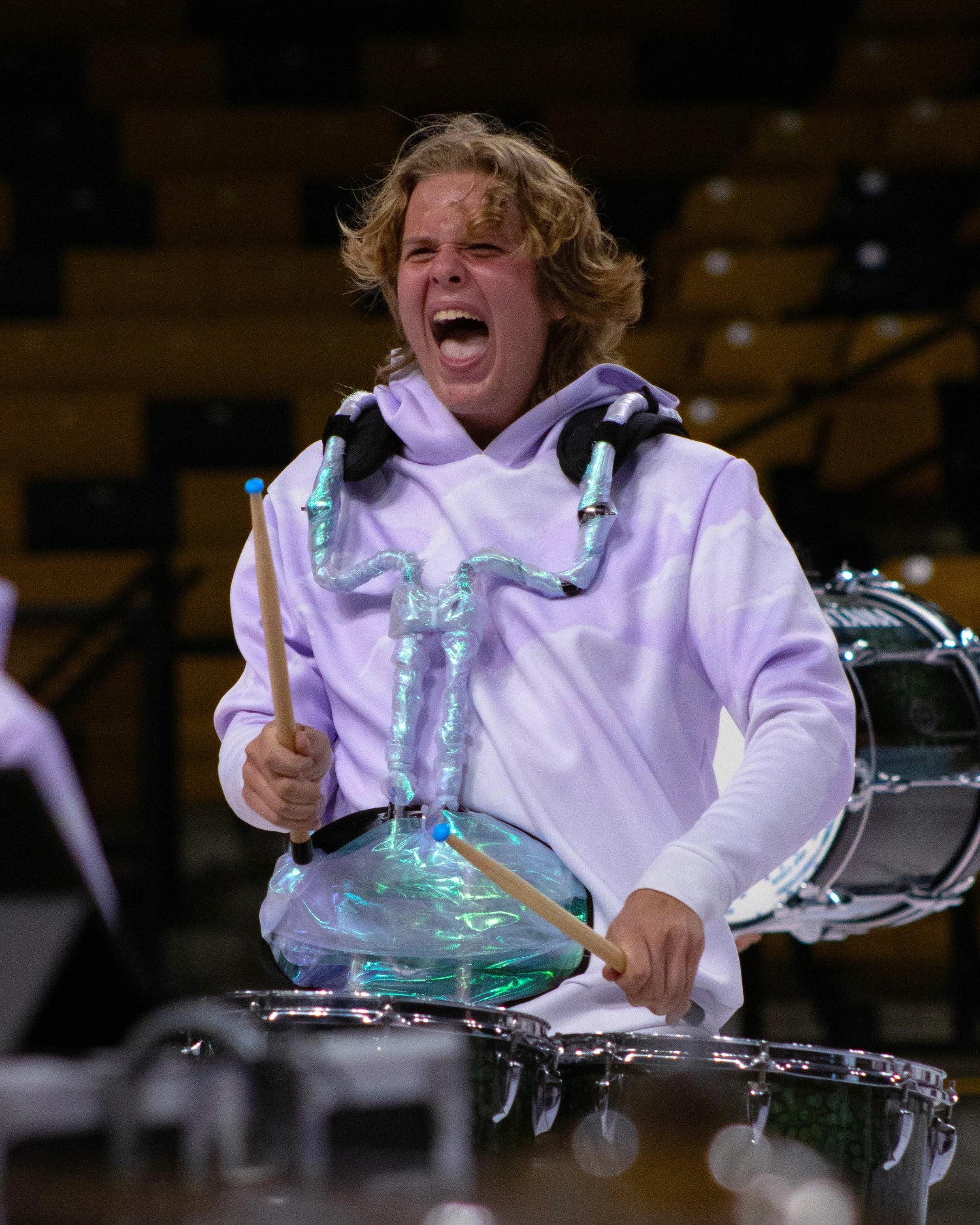Person playing drums on the floor in competition