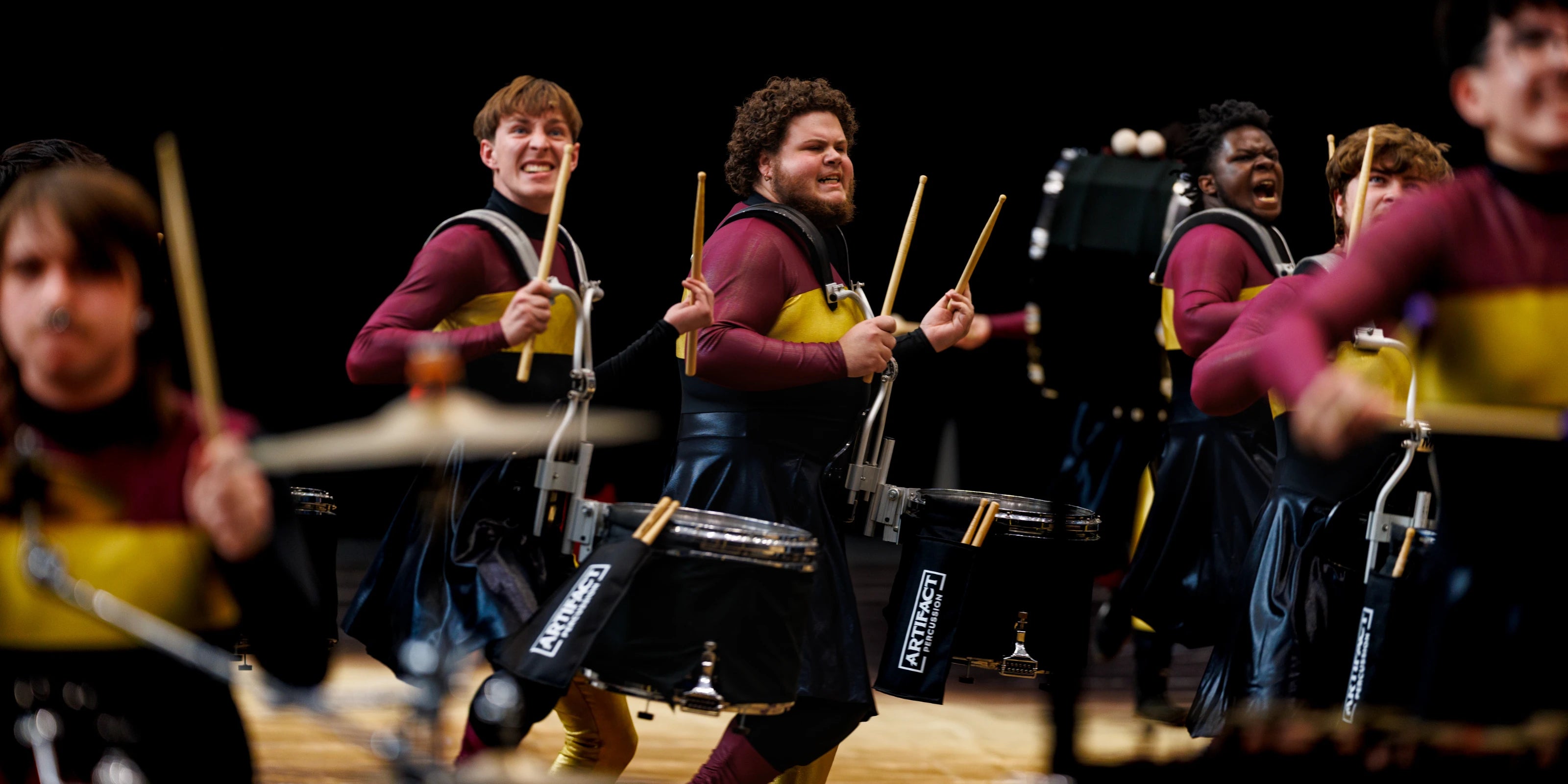Drummers performing on the floor with blurred background